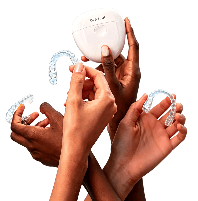 Hands holding dental aligners